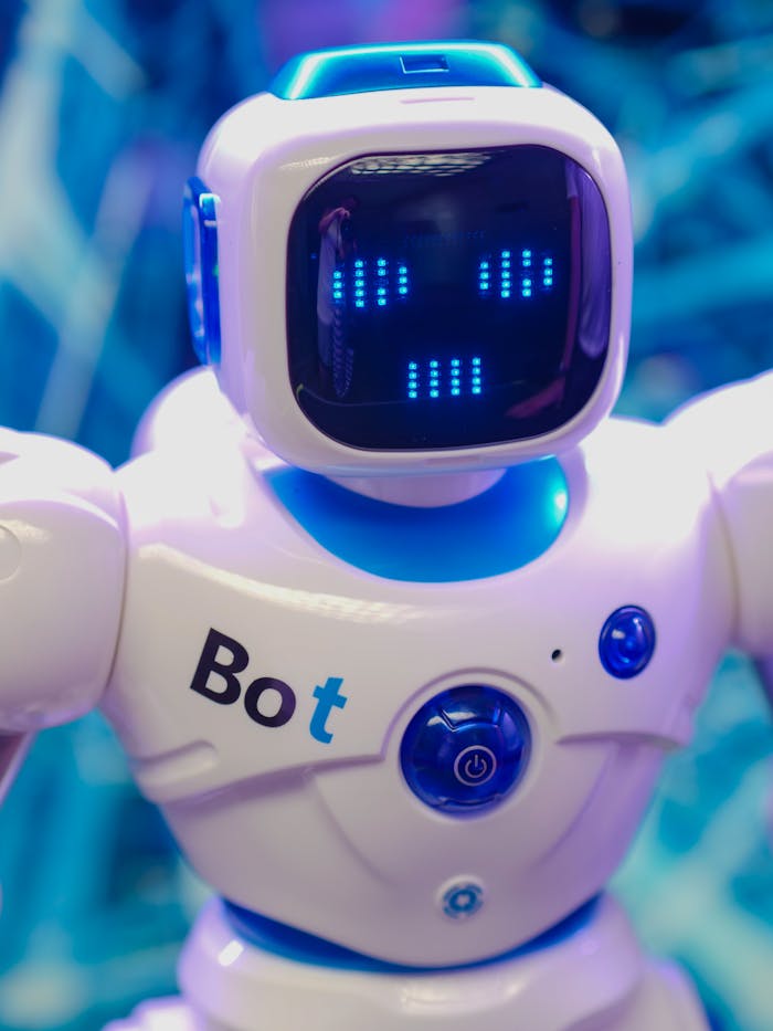our-services-3 White humanoid robot toy with illuminated face display representing modern technology.